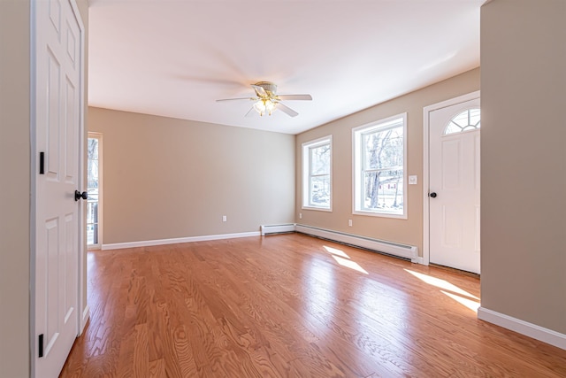 entryway with light wood-style flooring, ceiling fan, baseboards, and a baseboard radiator