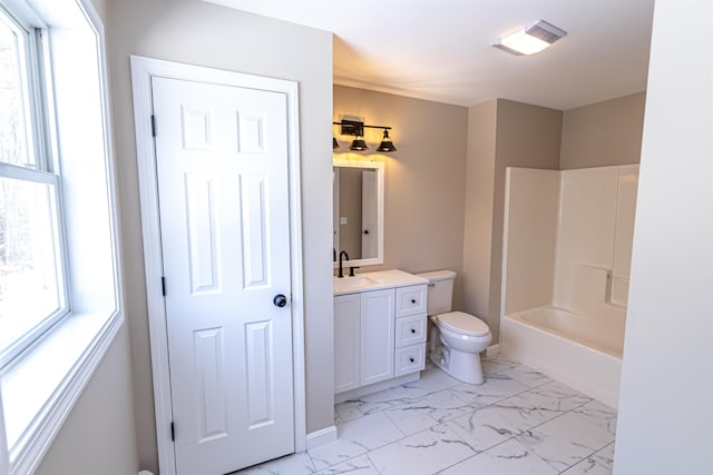 full bath featuring plenty of natural light, toilet, marble finish floor, and vanity