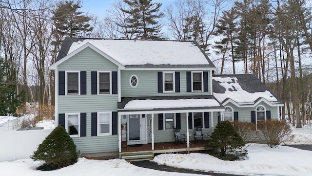 view of front of house with covered porch and fence