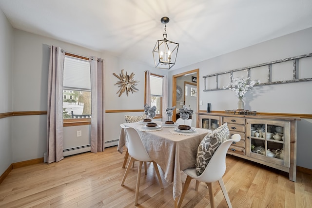 dining room with light wood-style floors, baseboards, and baseboard heating