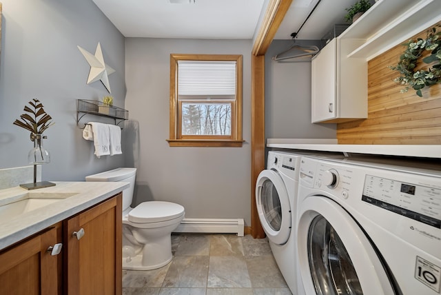 laundry area with baseboard heating, laundry area, and washing machine and clothes dryer