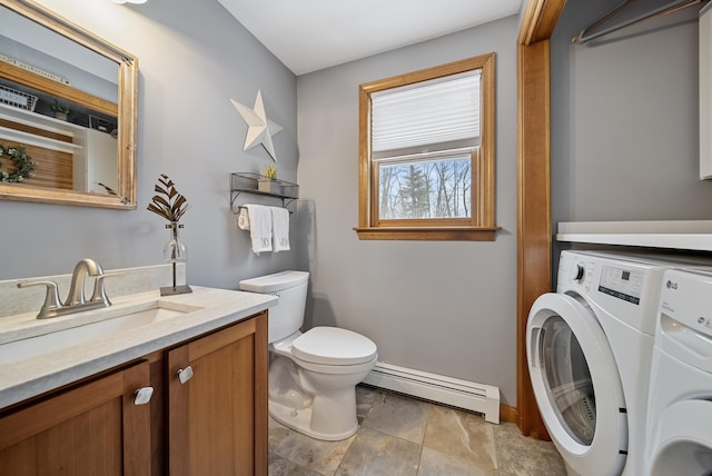 bathroom featuring vanity, baseboards, separate washer and dryer, toilet, and baseboard heating