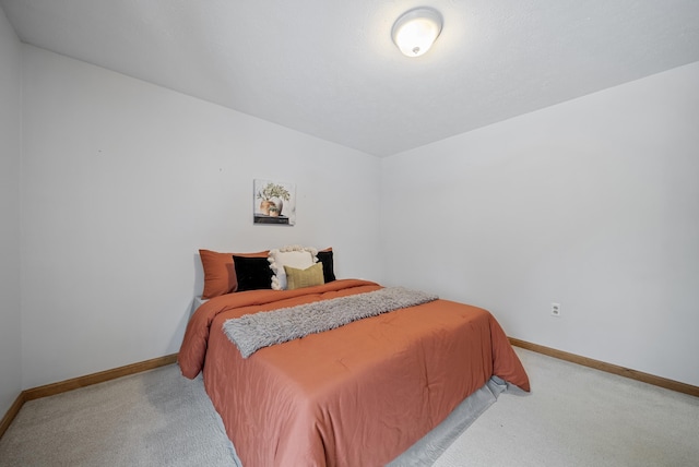 bedroom featuring baseboards and carpet