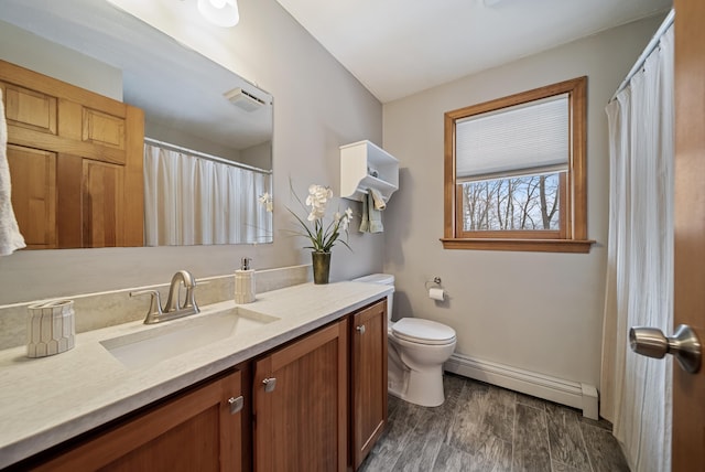 bathroom with visible vents, a baseboard heating unit, toilet, wood finished floors, and vanity