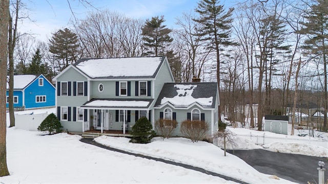 view of front of property featuring a porch and a chimney