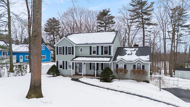 view of front of home with fence, covered porch, and a chimney