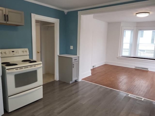 kitchen with dark wood-type flooring, ornamental molding, visible vents, and white electric stove