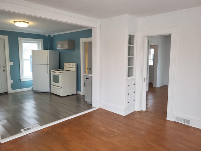 kitchen featuring dark wood-style floors, visible vents, white appliances, and crown molding