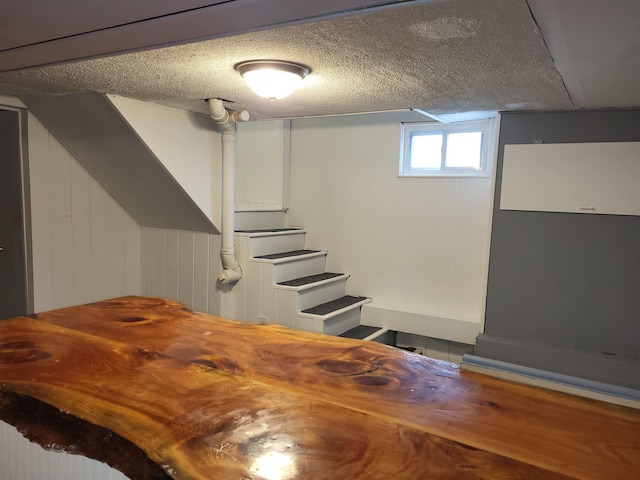 interior space with a textured ceiling and stairs