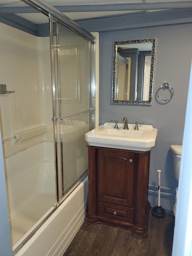 bathroom featuring vanity, toilet, and wood finished floors