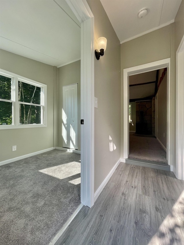 hallway with baseboards and wood finished floors