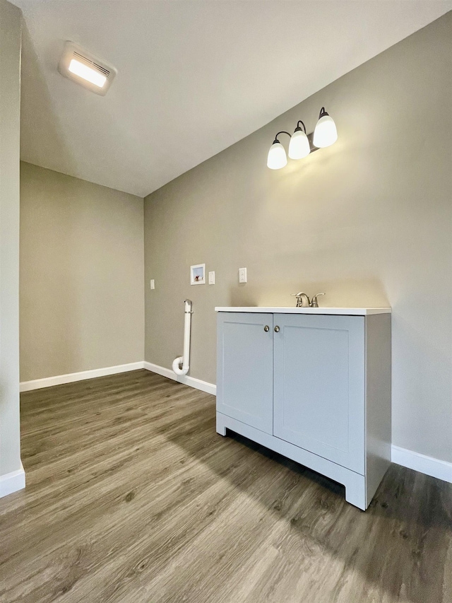 interior space featuring wood finished floors and baseboards