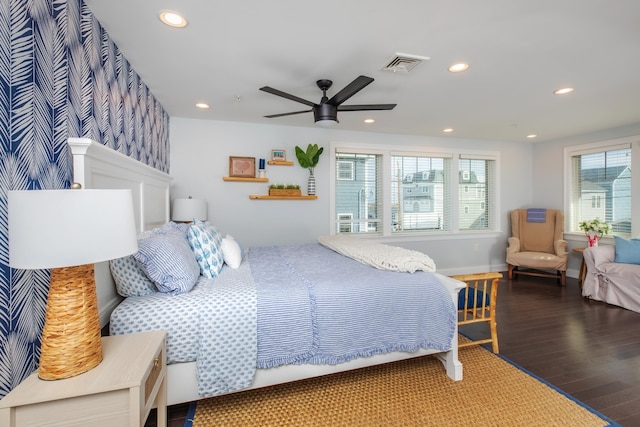 bedroom with recessed lighting, multiple windows, and wood finished floors