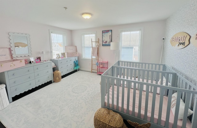 bedroom with baseboards, carpet, and wallpapered walls