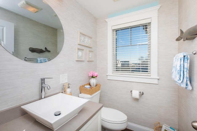 bathroom featuring toilet and vanity