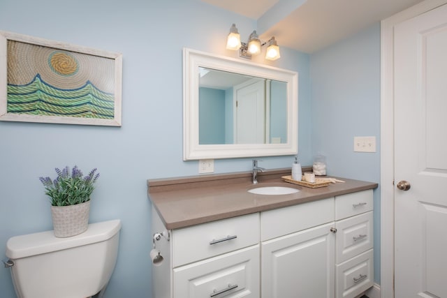 bathroom featuring toilet and vanity