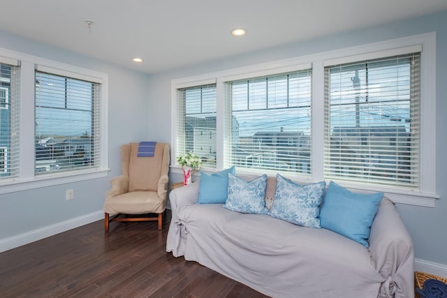 sitting room with dark wood finished floors, recessed lighting, and baseboards