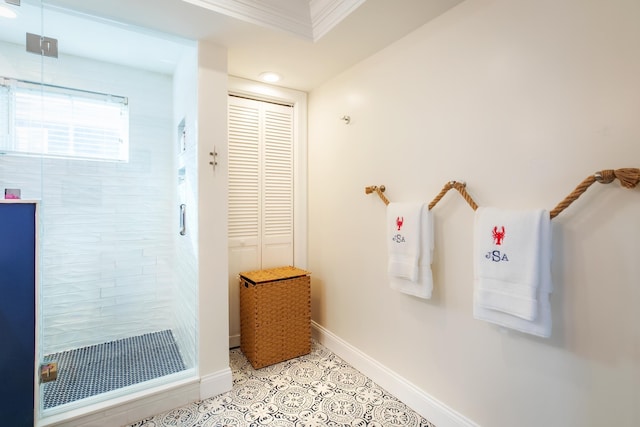 full bath with tile patterned flooring, a shower stall, baseboards, and ornamental molding