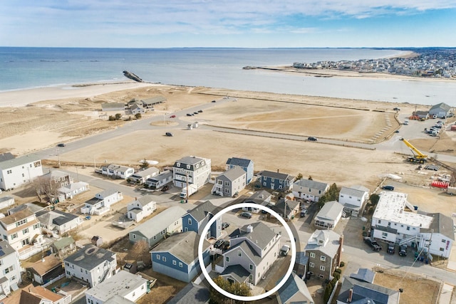 birds eye view of property featuring a beach view and a water view