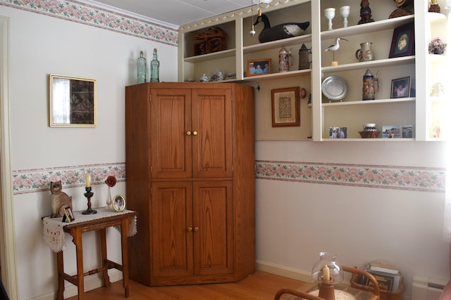 interior space featuring open shelves, light wood-type flooring, and brown cabinets