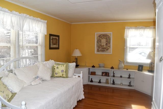 bedroom with crown molding and wood finished floors