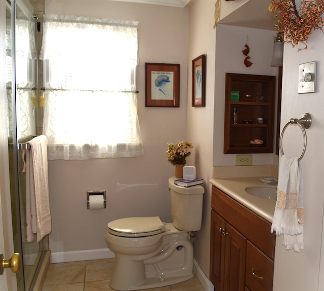 bathroom featuring tile patterned floors, plenty of natural light, toilet, and vanity