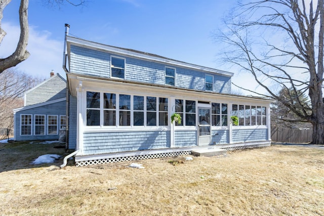 view of front of home featuring a sunroom