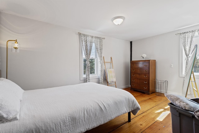 bedroom with baseboards and hardwood / wood-style floors