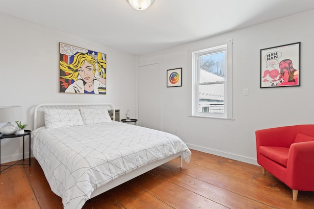 bedroom featuring baseboards and wood-type flooring