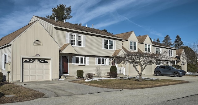 view of front of home with aphalt driveway and a garage