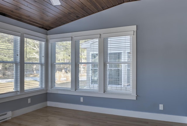 unfurnished sunroom with lofted ceiling, baseboard heating, and wood ceiling