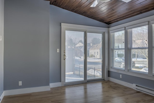 empty room featuring wood finished floors, baseboards, vaulted ceiling, wooden ceiling, and baseboard heating