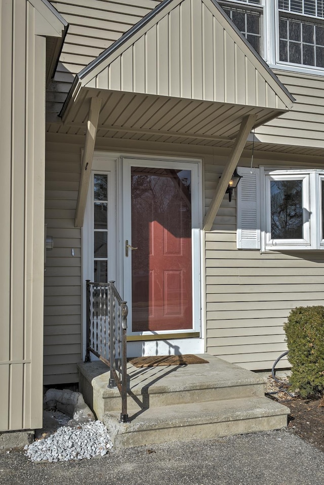 view of exterior entry featuring board and batten siding