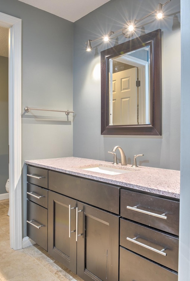 bathroom with tile patterned floors, toilet, and vanity