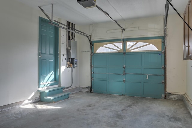 garage featuring electric panel and a garage door opener