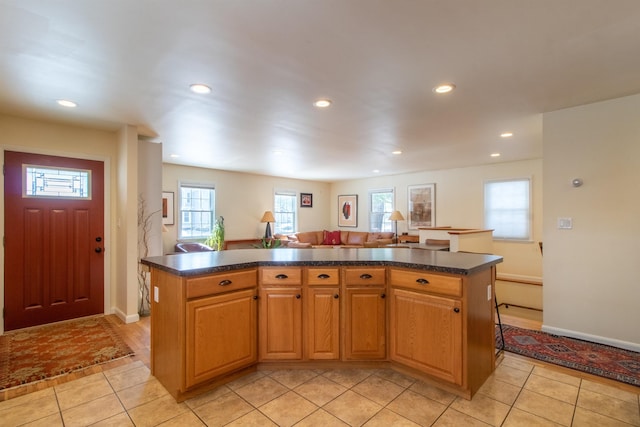 kitchen featuring dark countertops, light tile patterned floors, and recessed lighting