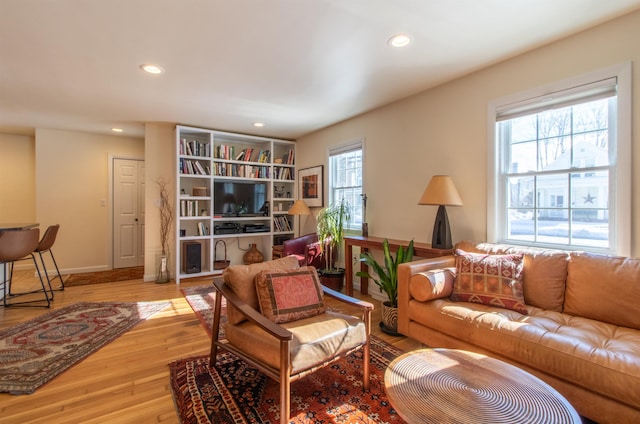 living room featuring recessed lighting, wood finished floors, and baseboards