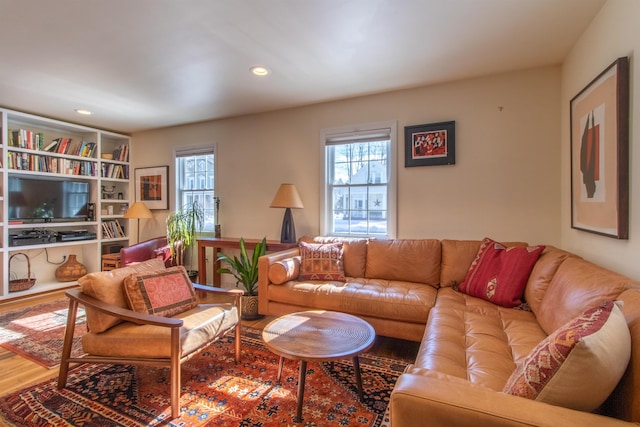 living room with plenty of natural light, wood finished floors, and recessed lighting