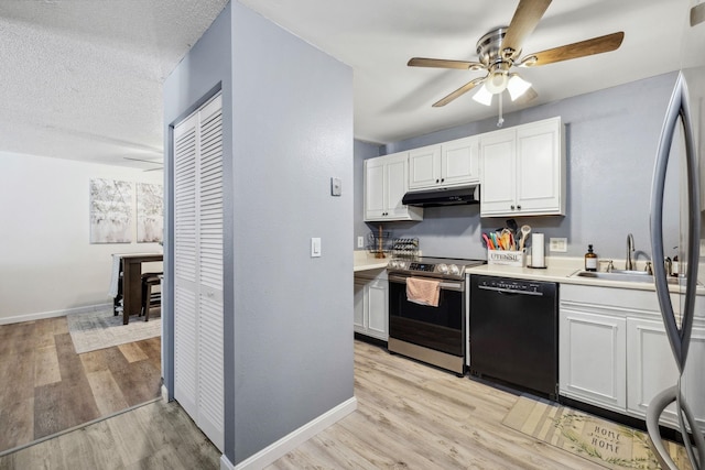 kitchen with a sink, black dishwasher, electric stove, under cabinet range hood, and light wood-type flooring