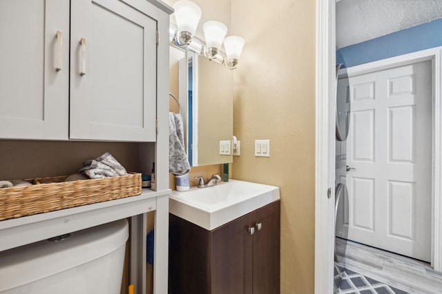 bathroom featuring vanity, an inviting chandelier, and wood finished floors