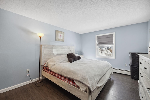 bedroom featuring a textured ceiling, dark wood-style floors, baseboards, and a baseboard radiator