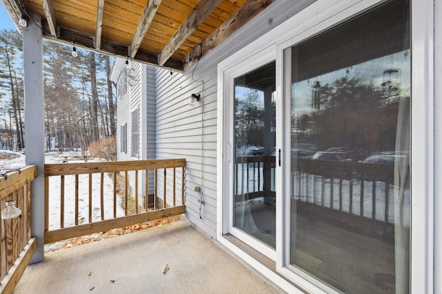 view of snow covered back of property