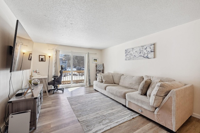 living area featuring a textured ceiling and light wood-type flooring