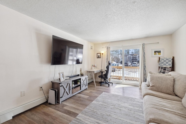 living room with a textured ceiling, wood finished floors, baseboards, and a baseboard radiator