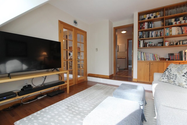 living room featuring baseboards and wood finished floors