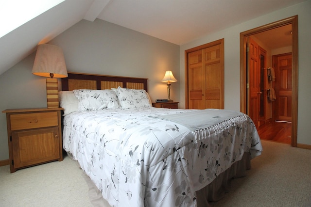 bedroom featuring light colored carpet, baseboards, and lofted ceiling