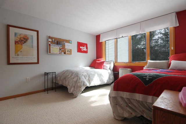 carpeted bedroom featuring baseboards