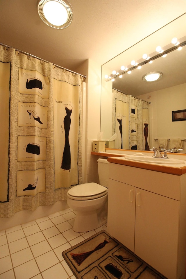 bathroom with tile patterned floors, toilet, a shower with shower curtain, and vanity