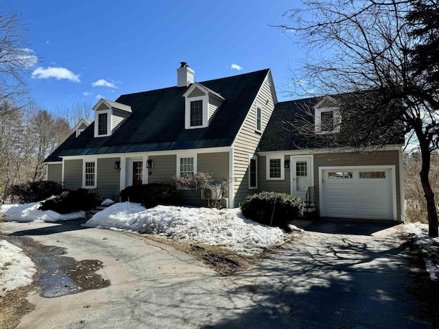 cape cod house with aphalt driveway and a chimney