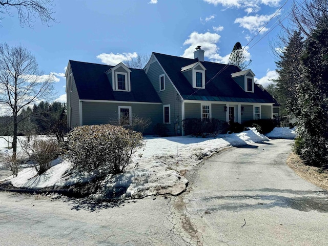 cape cod-style house with a chimney